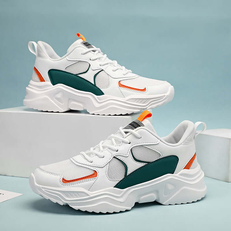 Chunky white and teal breathable sneakers with orange accents, ideal for all seasons and casual wear.