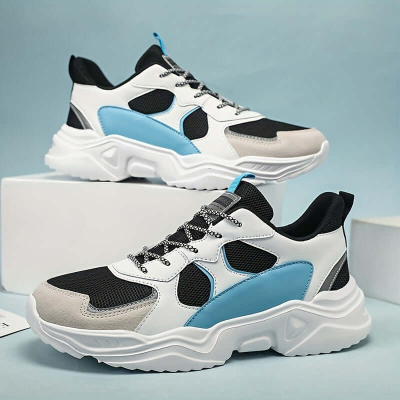 Men's white and teal chunky breathable mesh sneakers with lace closure and EVA sole.